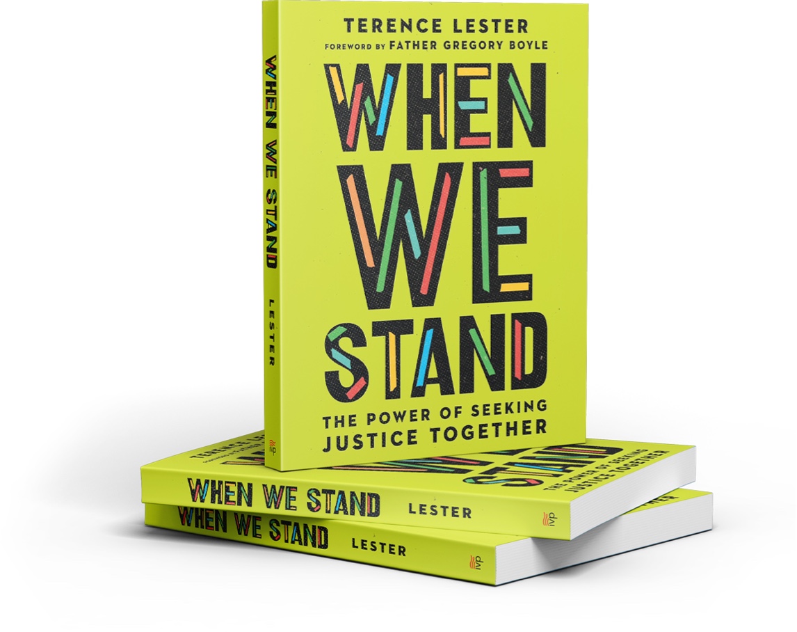 standing book of when we stand book stacked on two other books